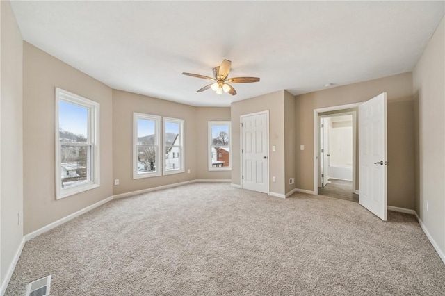 unfurnished bedroom with ceiling fan and light colored carpet