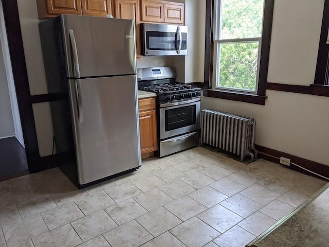 kitchen with radiator heating unit and stainless steel appliances