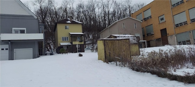 yard covered in snow with a garage