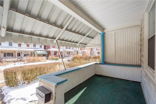 unfurnished sunroom with lofted ceiling with beams