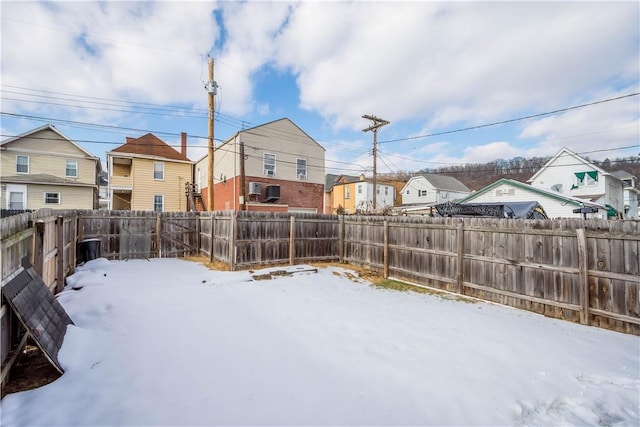 view of yard layered in snow