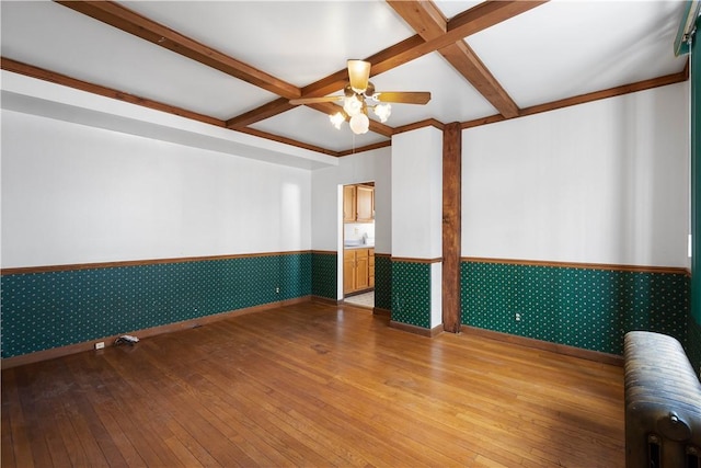 spare room featuring hardwood / wood-style floors, coffered ceiling, radiator, and ceiling fan