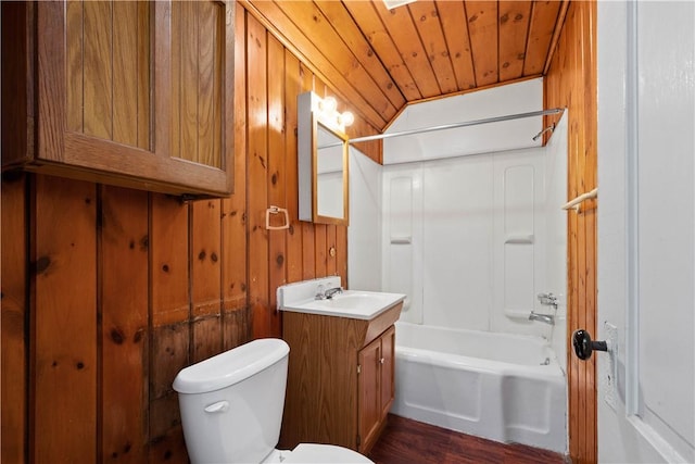 full bathroom featuring bathing tub / shower combination, vanity, toilet, wood walls, and wooden ceiling