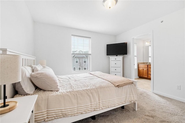 carpeted bedroom featuring ensuite bathroom