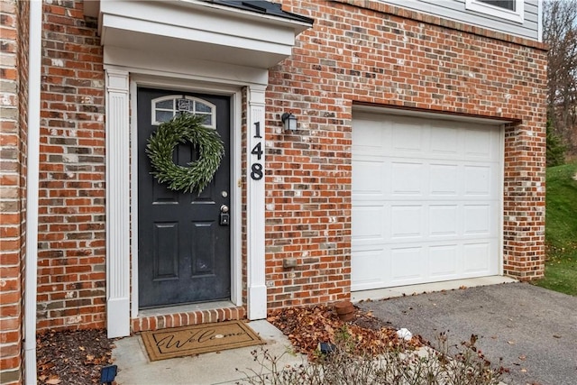 view of exterior entry with a garage