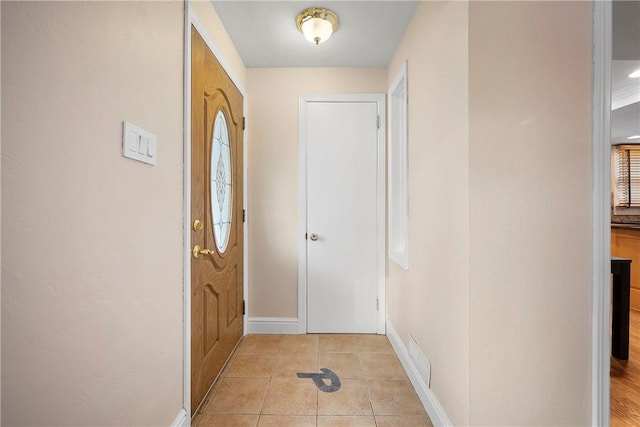 doorway featuring light tile patterned floors