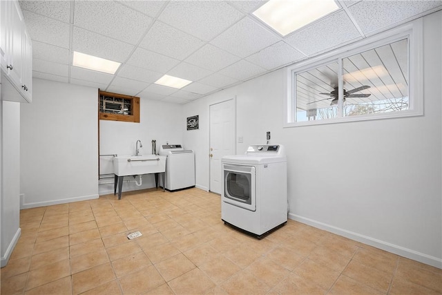 clothes washing area with cabinets, sink, independent washer and dryer, ceiling fan, and light tile patterned floors