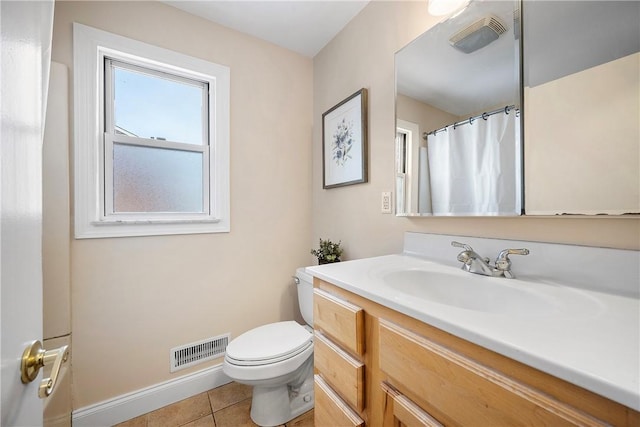 bathroom featuring toilet, tile patterned flooring, and vanity