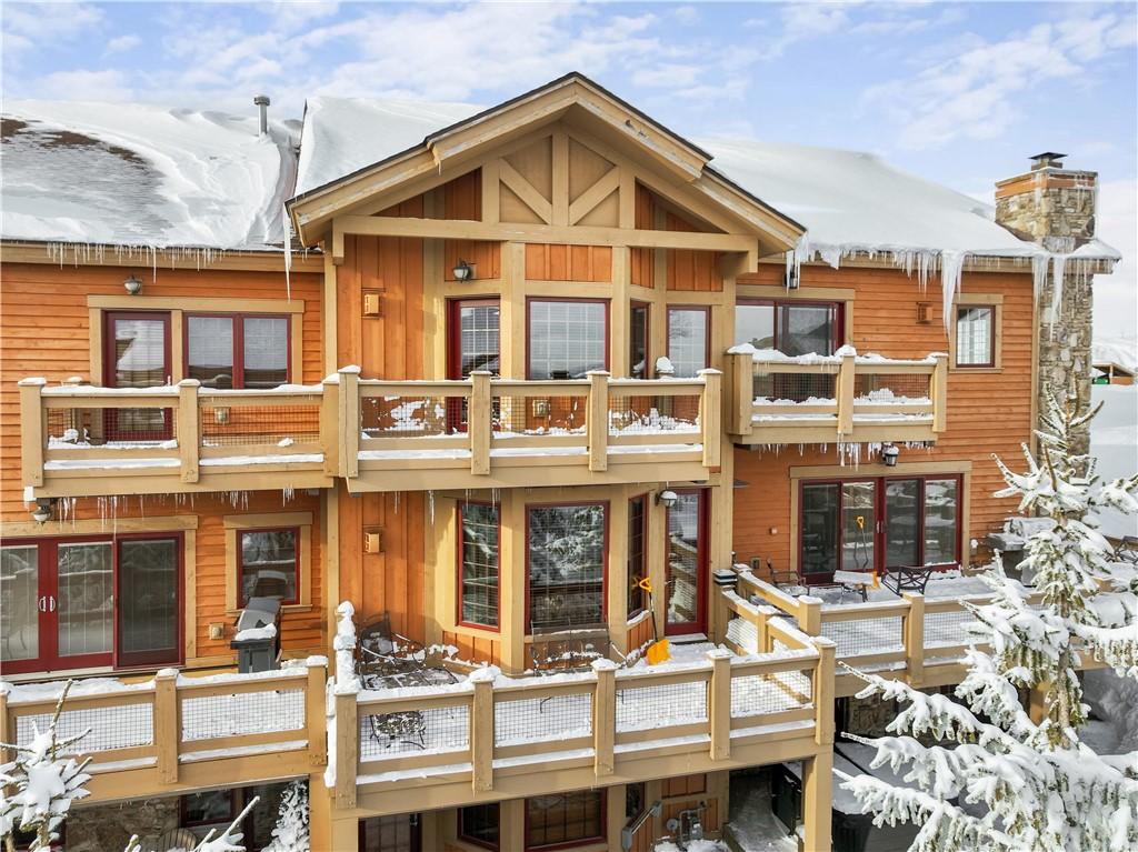 snow covered property featuring a balcony