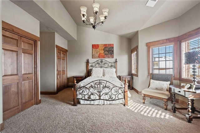 bedroom featuring a closet, vaulted ceiling, a chandelier, and carpet floors