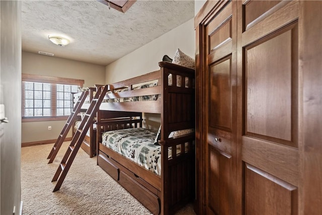 carpeted bedroom with a textured ceiling