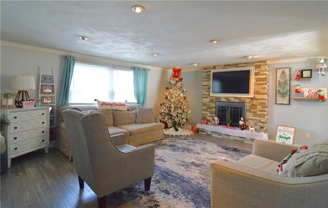 living room featuring crown molding, a stone fireplace, and dark hardwood / wood-style flooring