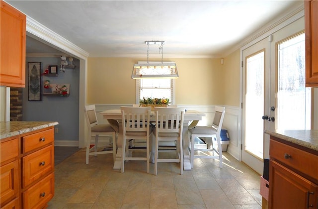 tiled dining area featuring ornamental molding