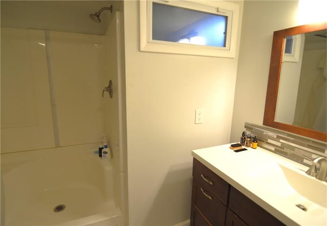 409 Himler Rd, Hempfield Twp Wml, PA 15601 - full bath with backsplash, vanity, a shower, and baseboards