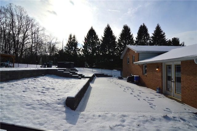 yard covered in snow with a jacuzzi