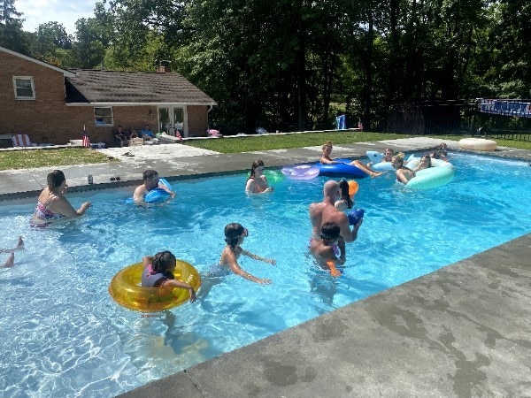 409 Himler Rd, Hempfield Twp Wml, PA 15601 - swimming pool featuring a patio area, an outbuilding, and view of wooded area