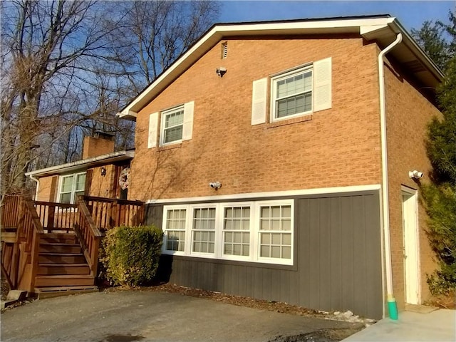409 Himler Rd, Hempfield Twp Wml, PA 15601 - view of home's exterior featuring a deck, stucco siding, and a security system
