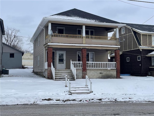 view of front of property featuring a balcony, central AC, and a porch