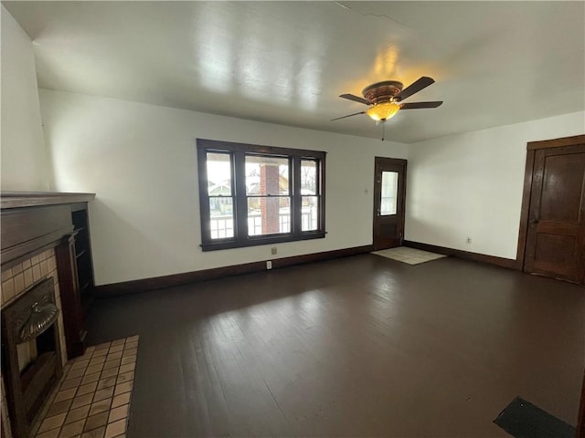 unfurnished living room with ceiling fan, dark hardwood / wood-style floors, and a fireplace