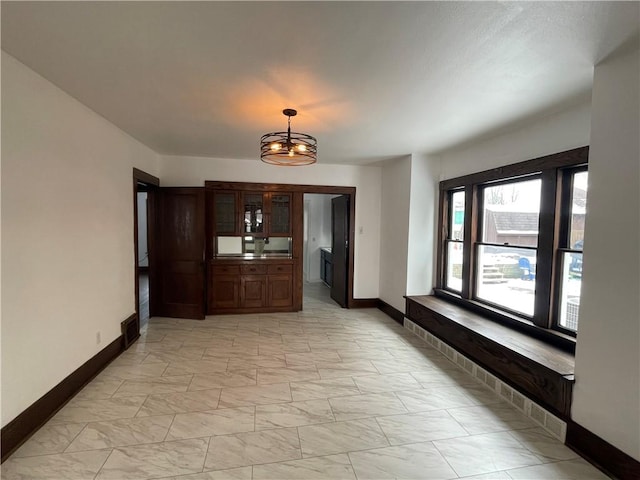 hallway with a chandelier