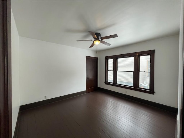 empty room featuring ceiling fan and dark hardwood / wood-style flooring