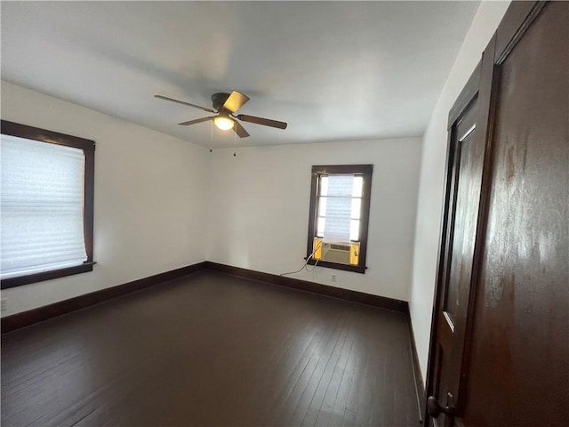 empty room with dark wood-type flooring, cooling unit, and ceiling fan