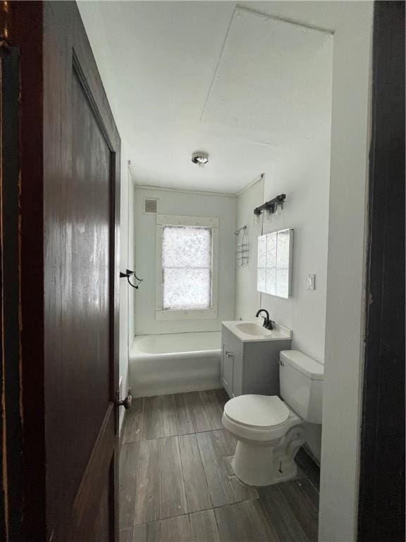 full bathroom featuring vanity, hardwood / wood-style flooring,  shower combination, and toilet