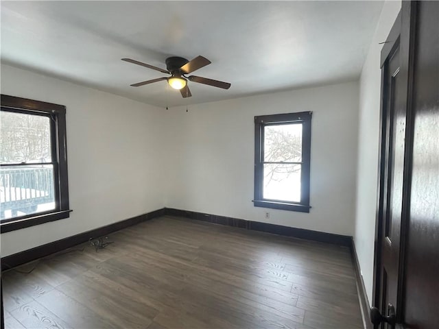 empty room featuring ceiling fan and dark wood-type flooring