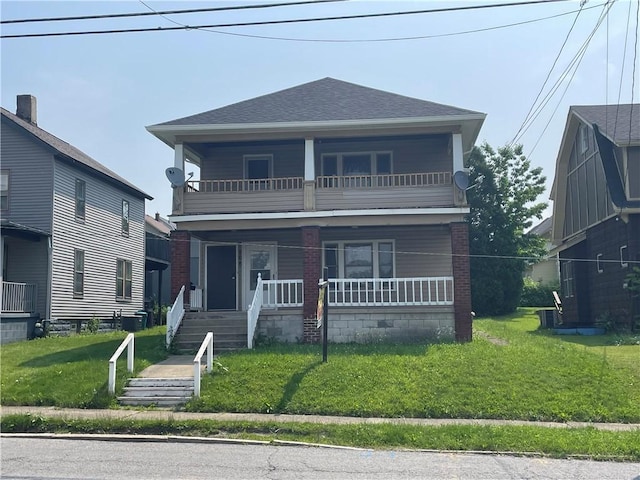 906 N Mercer St, New Castle/1St, PA 16101 - view of front facade featuring a balcony, a porch, brick siding, a front yard, and roof with shingles