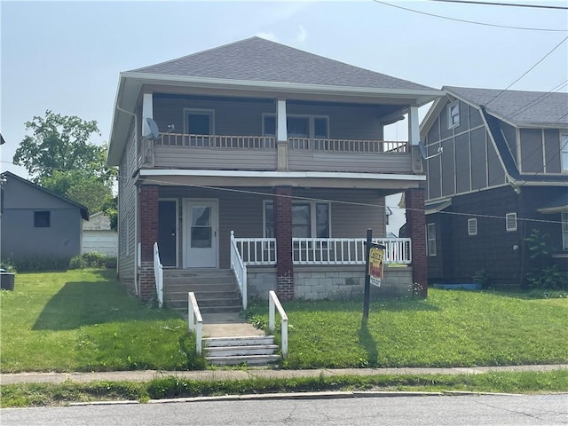 906 N Mercer St, New Castle/1St, PA 16101 - view of front of house featuring a balcony, covered porch, a shingled roof, and a front lawn