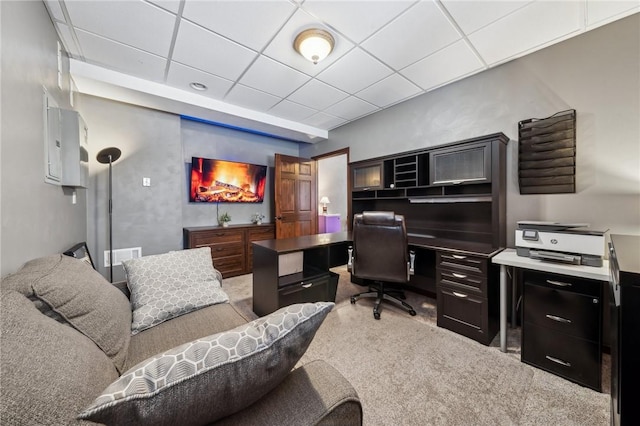 office space featuring carpet floors and a paneled ceiling