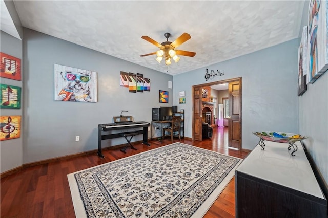 office space featuring dark wood-type flooring, a textured ceiling, and ceiling fan