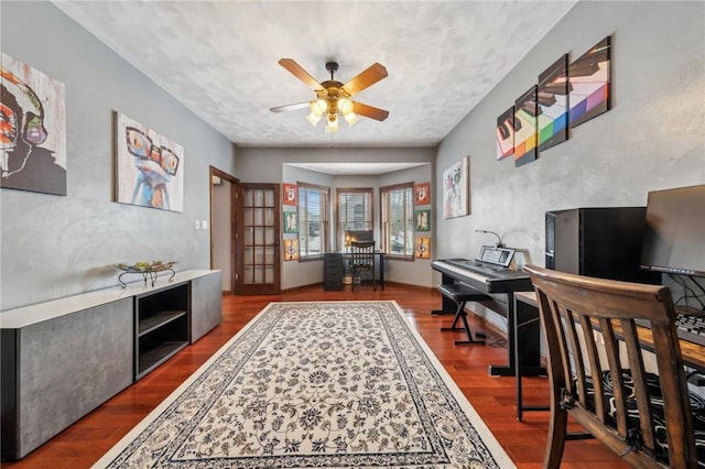 office area with ceiling fan and dark hardwood / wood-style flooring