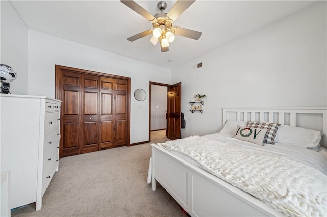 carpeted bedroom with a closet and ceiling fan