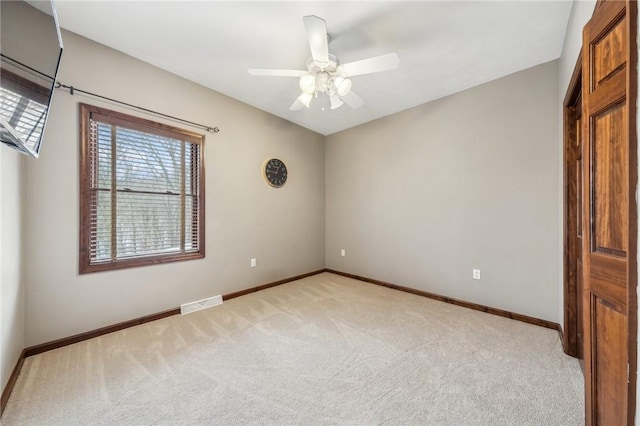 unfurnished bedroom featuring ceiling fan and light colored carpet