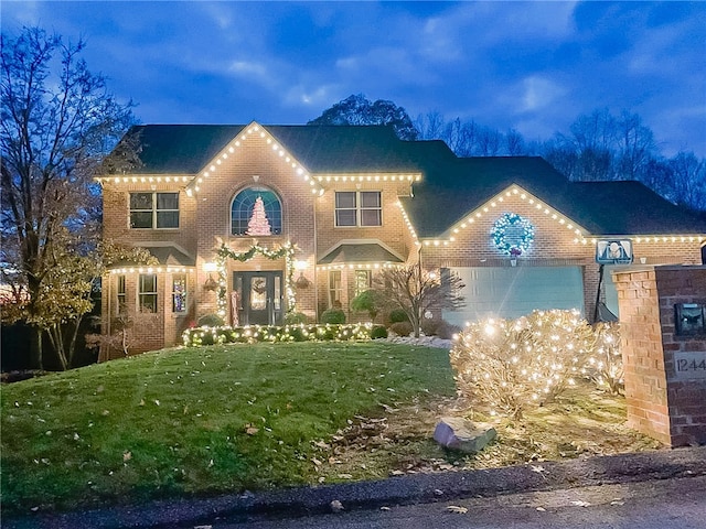 view of front of property with a garage and a front yard