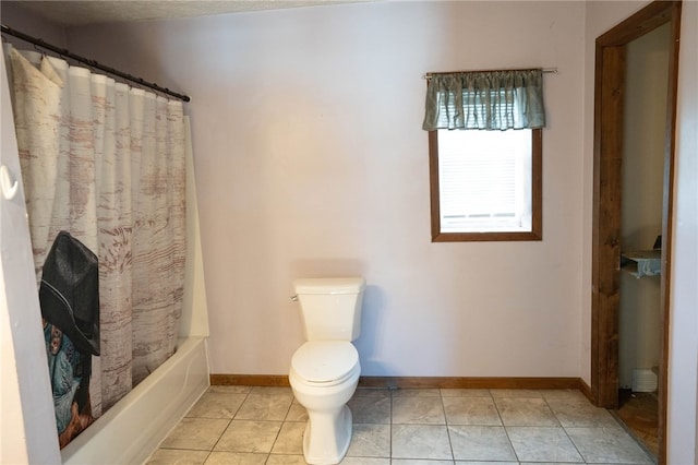 bathroom with shower / bath combination with curtain, tile patterned floors, and toilet