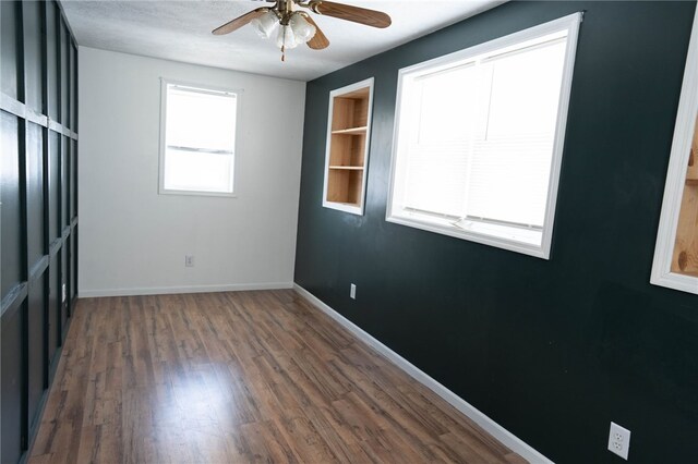 unfurnished room featuring ceiling fan and dark hardwood / wood-style flooring