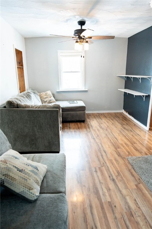 living room with hardwood / wood-style flooring and ceiling fan