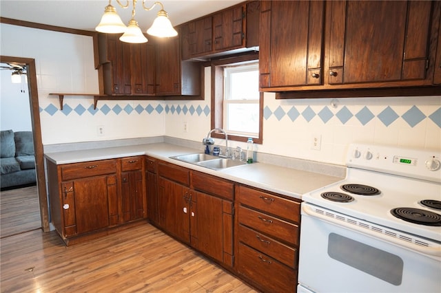 kitchen featuring pendant lighting, sink, white range with electric stovetop, tasteful backsplash, and light wood-type flooring