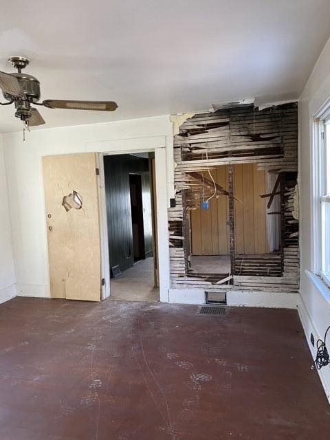 interior space featuring concrete flooring and ceiling fan