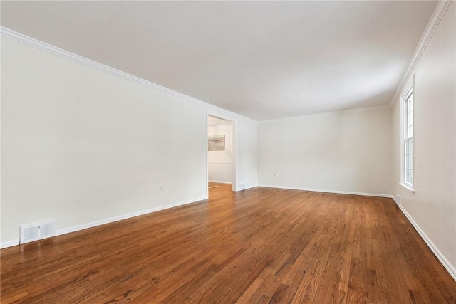 spare room with ornamental molding and wood-type flooring