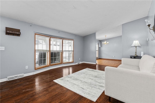 living room featuring dark hardwood / wood-style floors and a chandelier