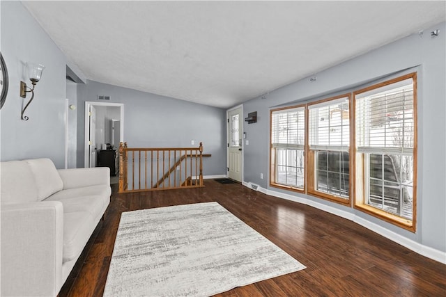 living room with lofted ceiling and dark wood-type flooring