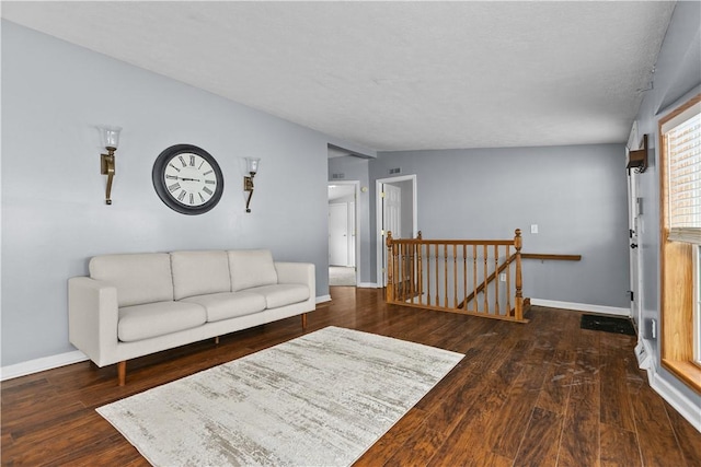 living room featuring lofted ceiling and dark hardwood / wood-style flooring