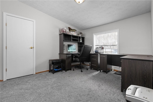 carpeted home office with a textured ceiling