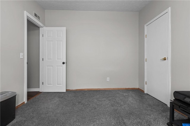 carpeted bedroom with a textured ceiling