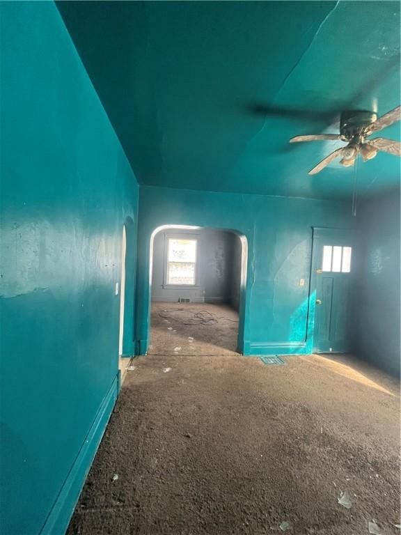 unfurnished room featuring plenty of natural light and ceiling fan