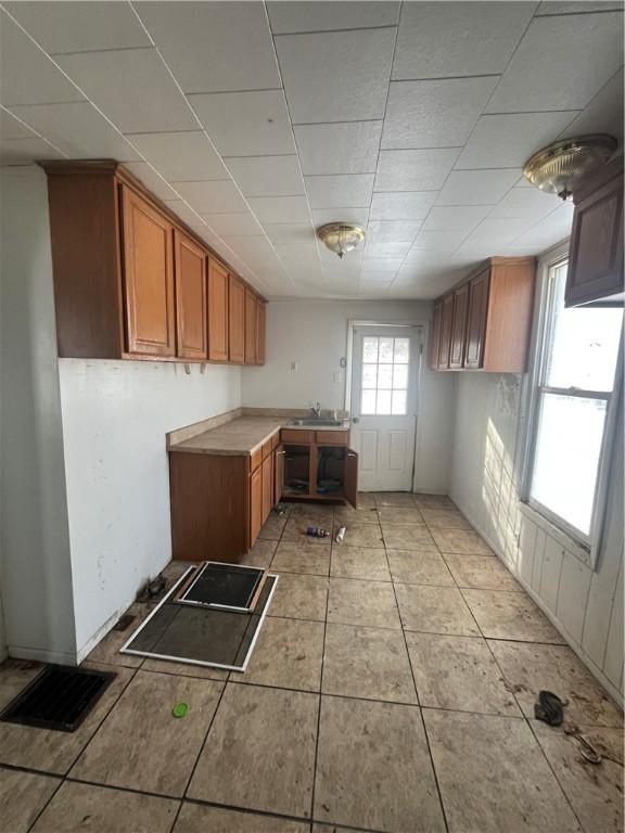 kitchen featuring sink and light tile patterned floors