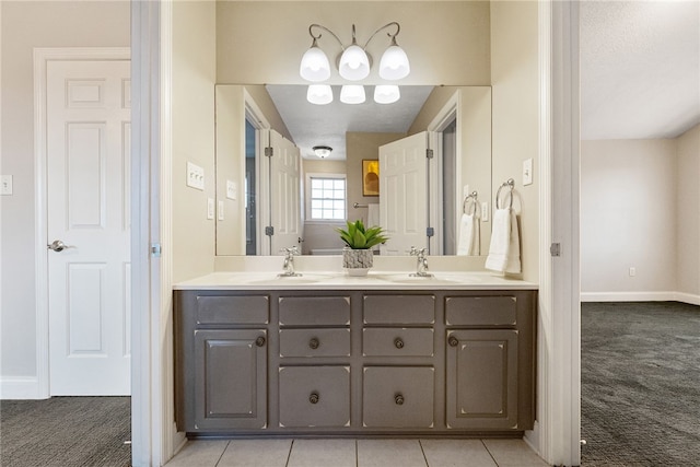 bathroom featuring vanity, tile patterned floors, and a textured ceiling